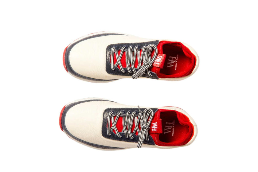 Women's navy and red Lynx Deerskin Golf Shoes with spikeless outsole and cushioned interior.