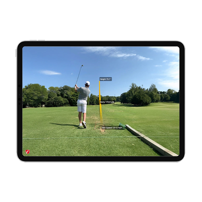 FlightScope Mevo Plus launch monitor showing tablet screen with golfer on driving range and shot data metrics