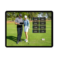 FlightScope Golf app on tablet showing coach instructing golfer with swing data overlays premium golf training equipment