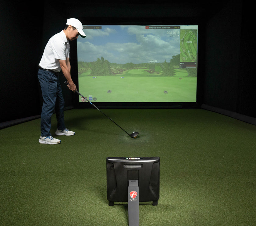 Golfer using the FlightScope X3C Launch Monitor in indoor simulator.
