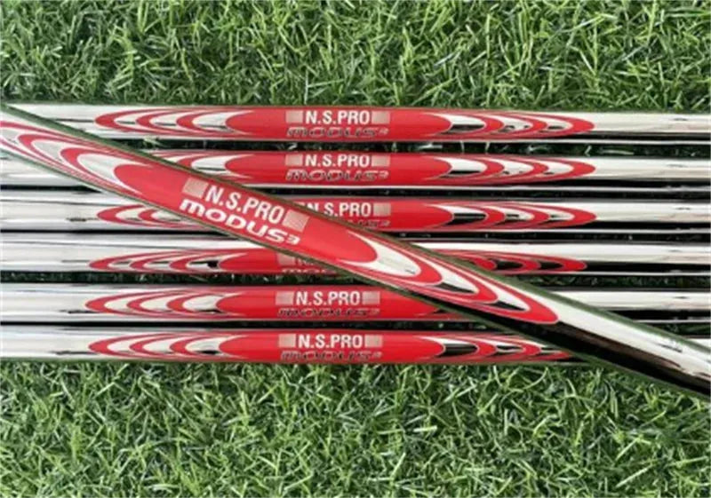 Close-up of Under Par Discount Golf forged golf club set with red and silver shafts on green grass