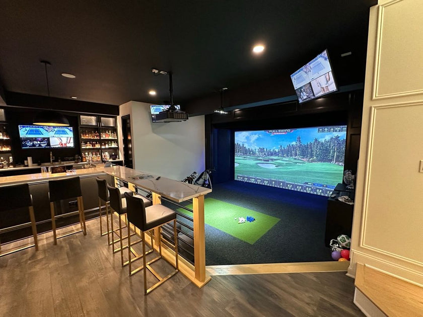 Full Swing Golf home golf simulator package in luxury basement with large projection screen hitting mat and bar seating