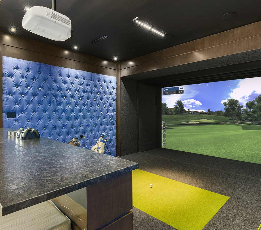 Full Swing Golf home golf simulator package in luxury indoor room with projector screen hitting mat and bar seating