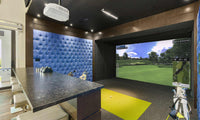 Full Swing Golf home golf simulator package in luxury indoor room with projector screen hitting mat and bar seating