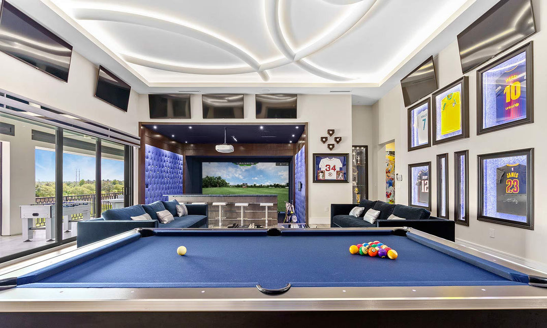 Full Swing Golf home golf simulator package in luxury game room with pool table seating and large simulator screen