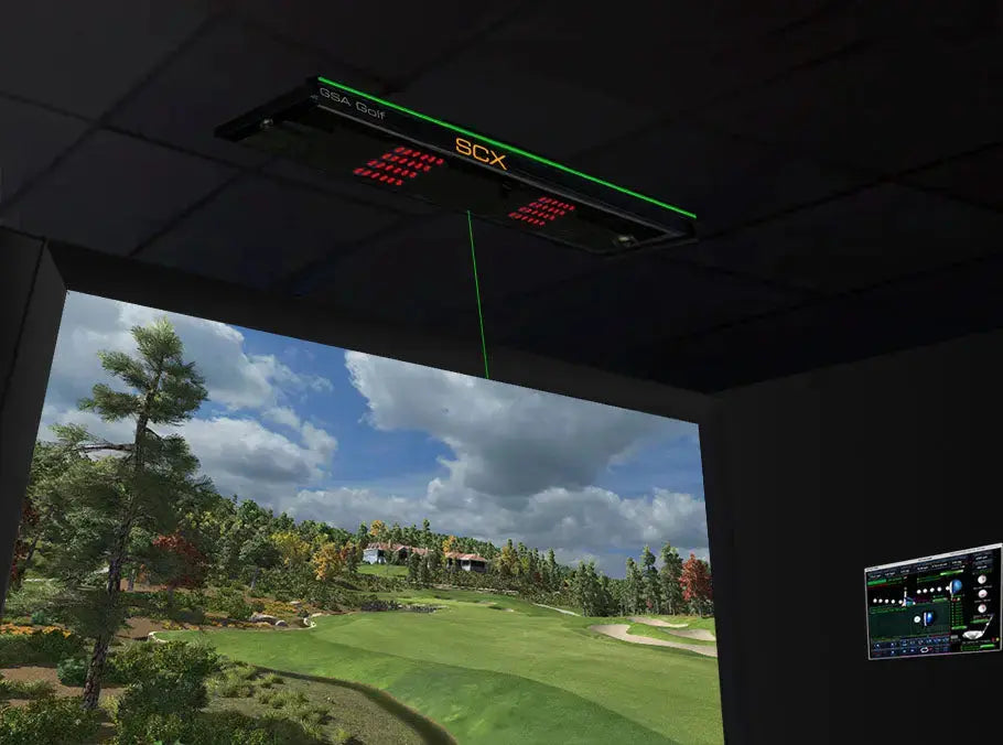 Ceiling mounted VisTrak SCX IR Lite Launch Monitor projecting green laser line onto indoor golf simulator screen