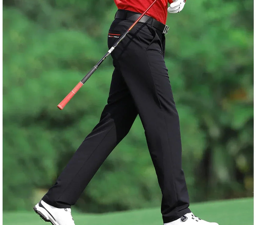 Man wearing slim fit golf pants for men while walking on the golf course with a golf club