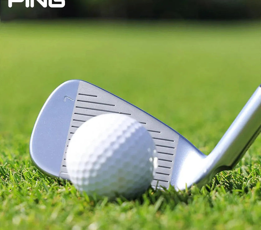 PING high rebound pitching wedge positioned next to a golf ball on lush grass