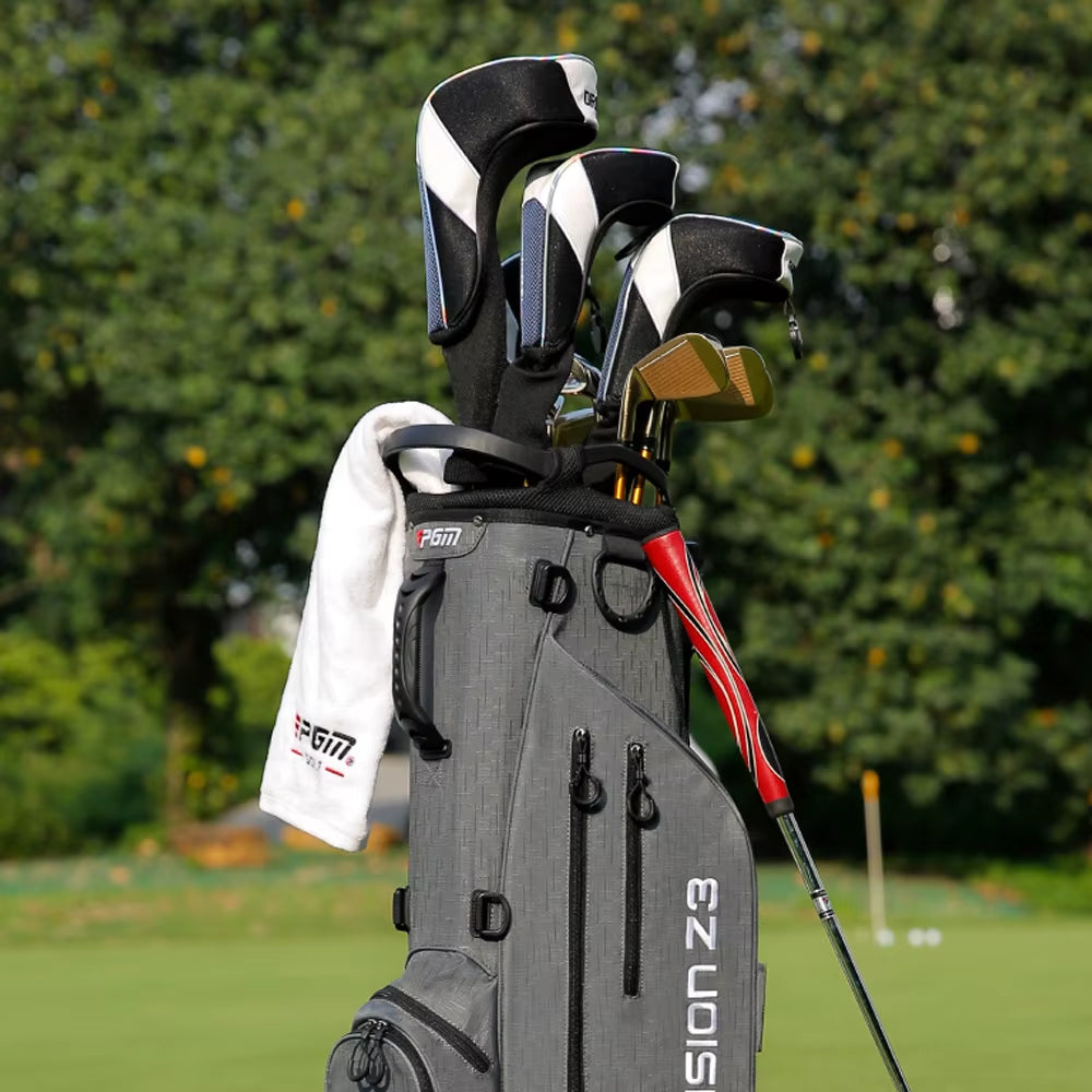 Portable golf rack bag from Under Par Discount Golf with clubs and towel displayed outdoors