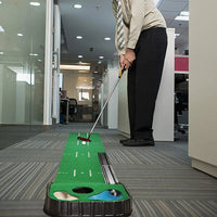 Under Par Discount Golf indoor putting mat set on office floor with man in dress pants practicing putt with two holes and guides