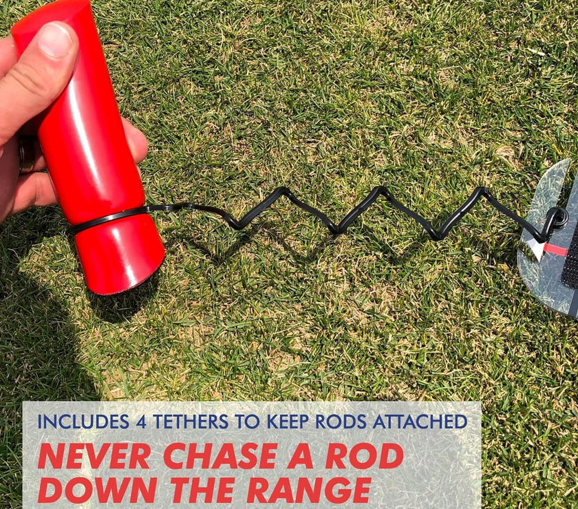 Hand holding red handle of Speed Trap swing trainer with black coiled tether attached to practice rod on grass