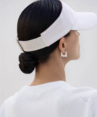 Amethyst Lucy white golf visor designed for stylish sun protection with adjustable strap