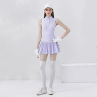 Women's golf polo shirt in light purple paired with a pleated skirt for stylish performance on the course