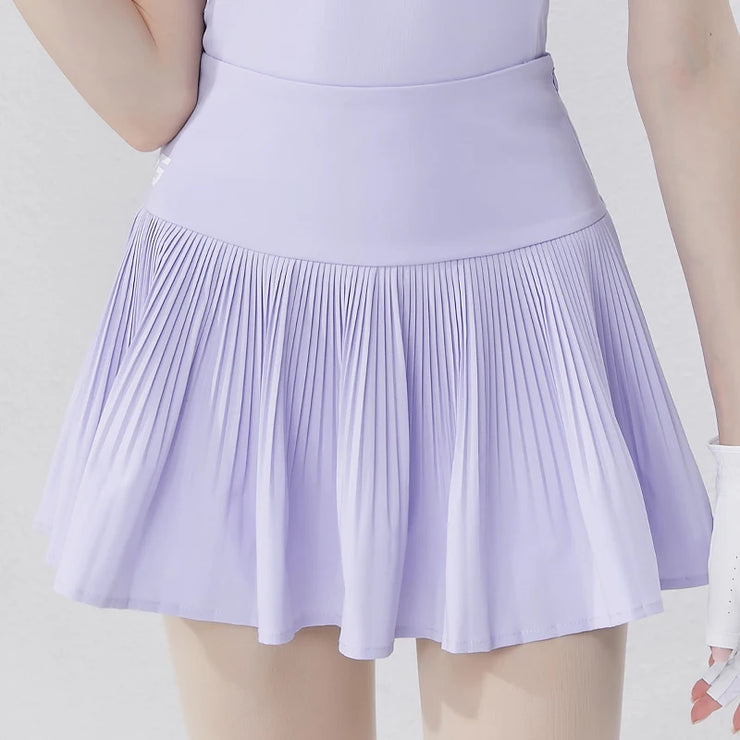 Light purple women's golf polo shirt paired with a pleated skirt for a stylish golf outfit