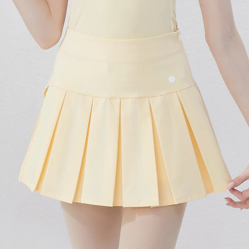 Stylish yellow women's golf polo shirt paired with a pleated golf skirt for a fashionable look on the course